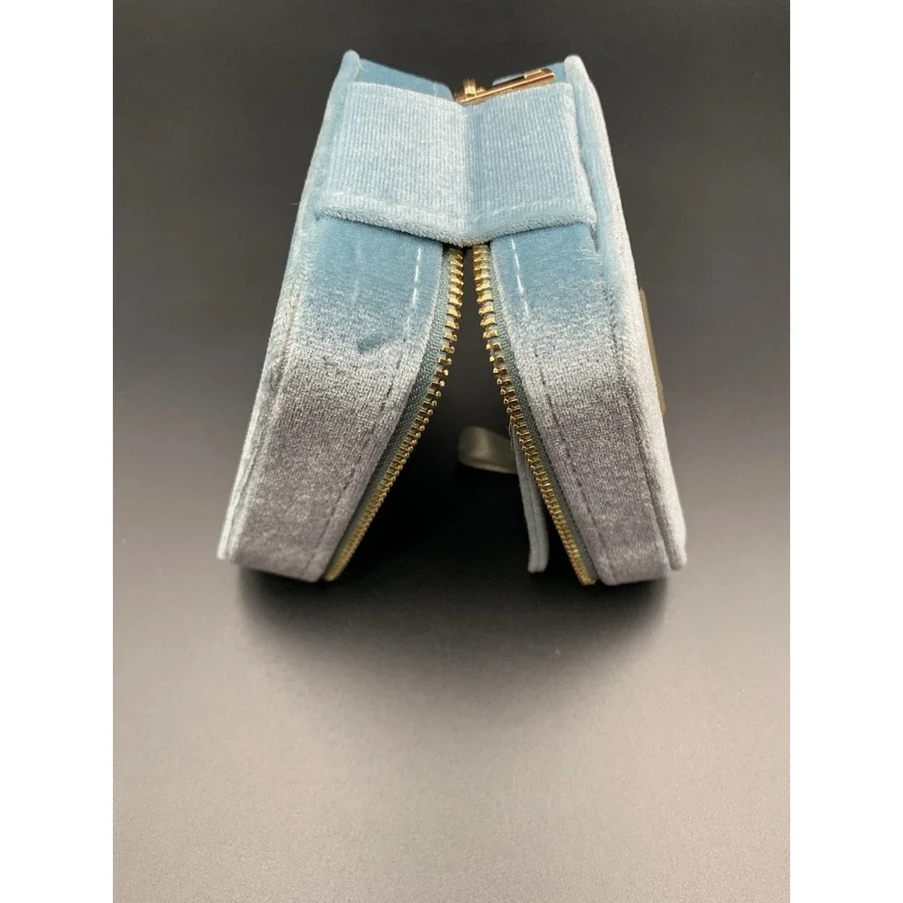 Small blue velvet jewelry box with a zipper